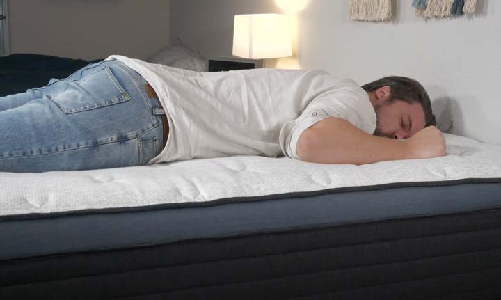 A man sleeps on his stomach on the Helix Twilight Luxe