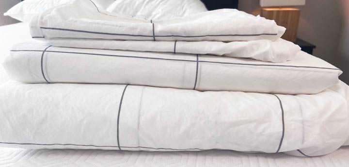 The pieces of the Brooklinen Classic Core Sheet Set stacked up.