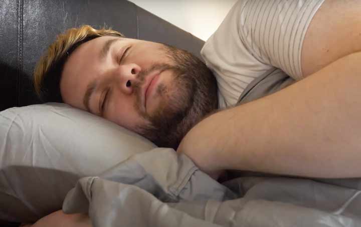A man sleeps on his side in Helix Tencel Sheets