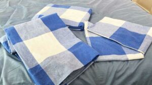 An image of the pieces that make up the Brooklinen Flannel Core Set placed on a bed.