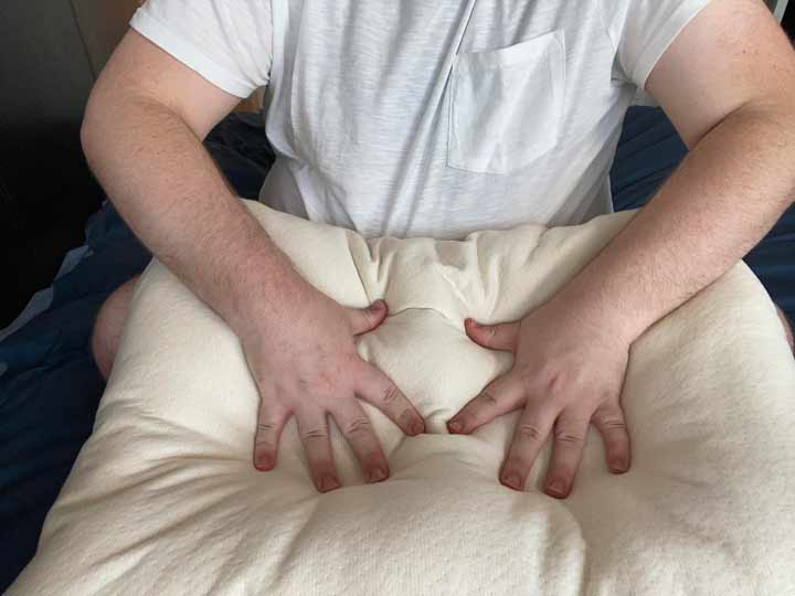 Hands feel the Birch Organic pillow