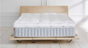 An image of the Brooklinen Down Topper spread across a mattress.