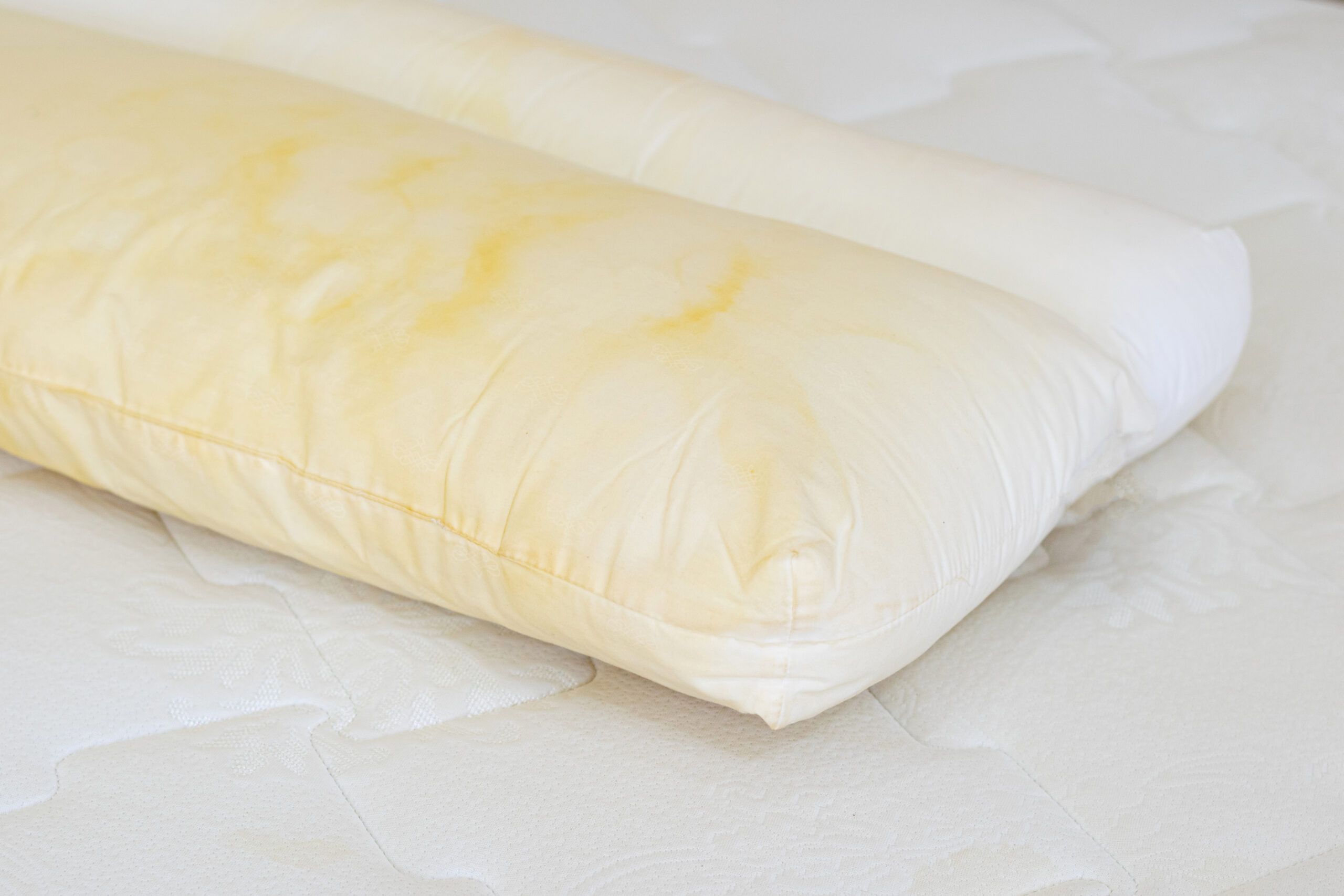 White pillow with yellow stains from use