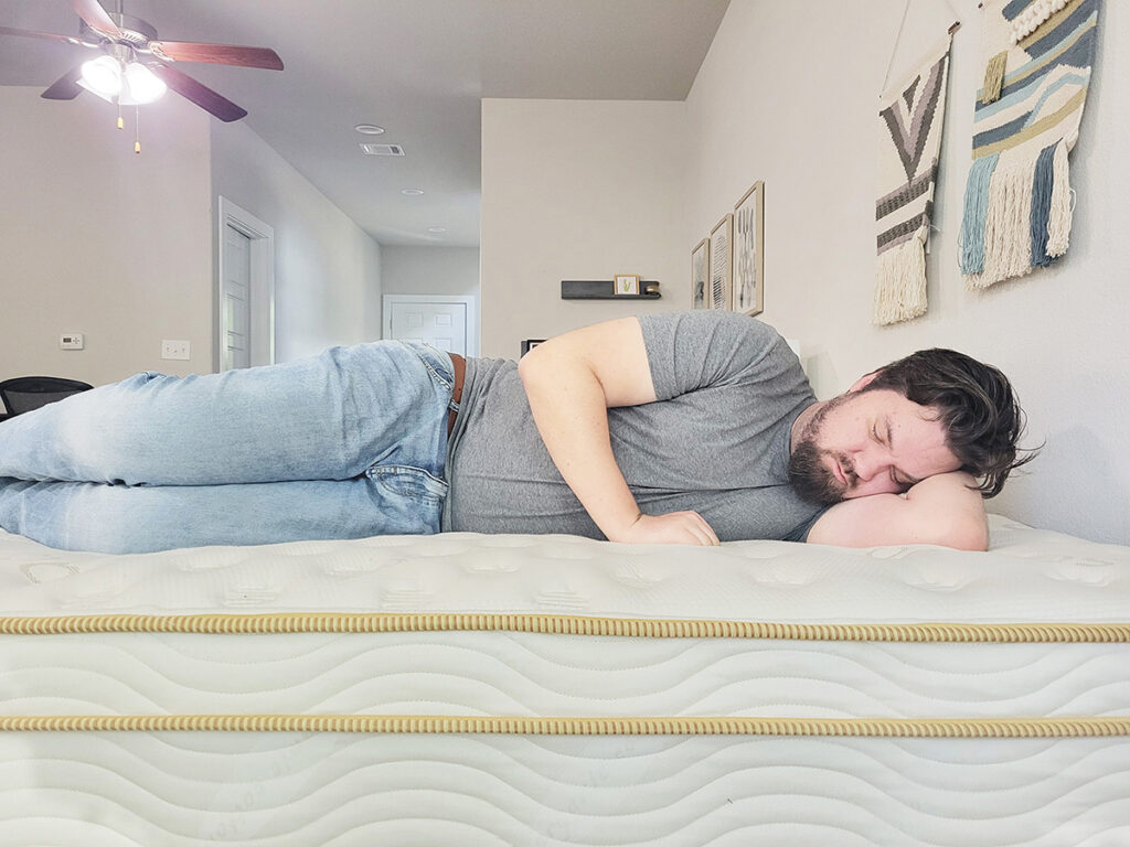 man side sleeping on the Saatva mattress