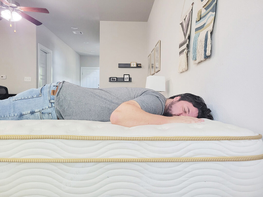 man sleeping on his stomach on the Saatva mattress