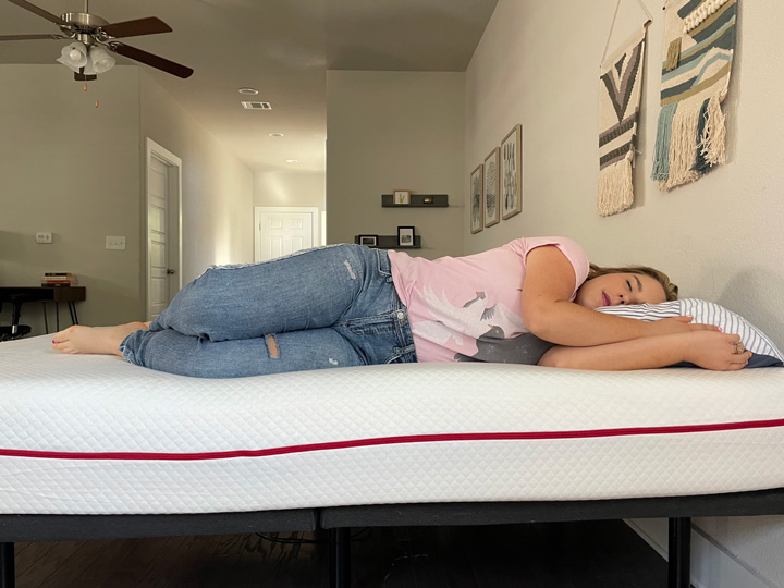 A woman sleeps on her side on the Douglas mattress