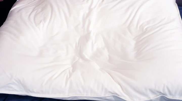 A picture of the white, slightly ruffled, cover for the Helix Down & Feather pillow.