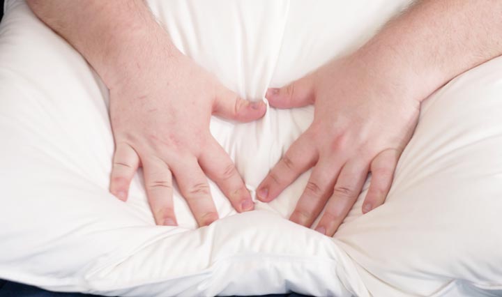 Two hands press into the Helix Down & Feather Pillow