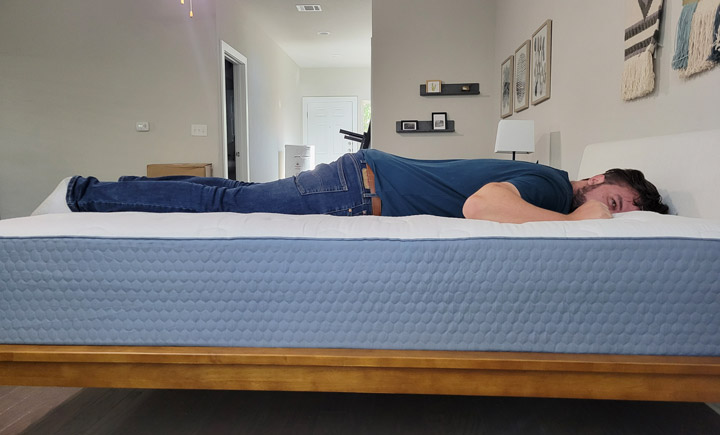 A man sleeps on his side on the Molecule Hybrid mattress