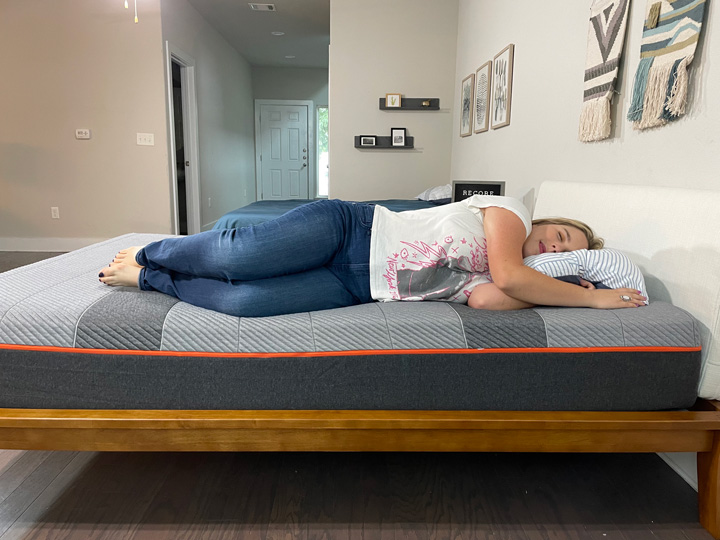 A woman sleeps on her side on the Recore mattress