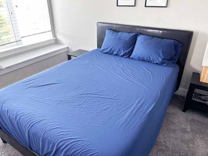 An image of the navy Sweave Eucalyptus Sheets dressed on a bed