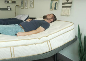 A wide shot of a Saatva mattress on the Lineal adjustable base