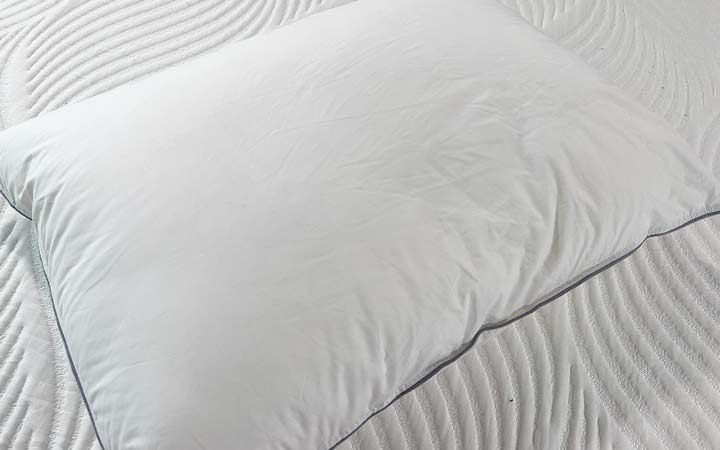 The white, cotton cover of the Tuft & Needle Down pillow.