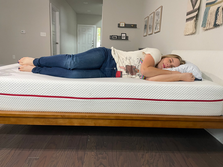 A woman sleeps on her side on the Douglas Alpine mattress