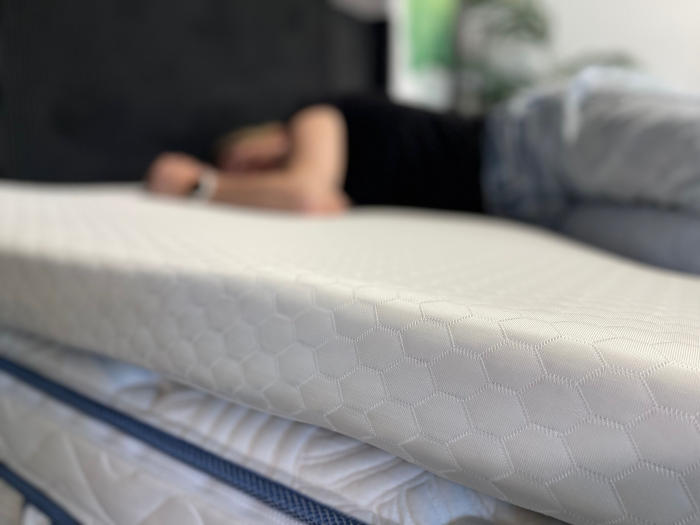 Helix GlacioTex Topper with a blurry side sleeper