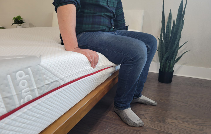 A man sits near the edge of the Douglas Summit mattress