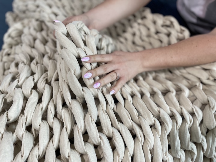 A woman holds the Douglas weighted blanket