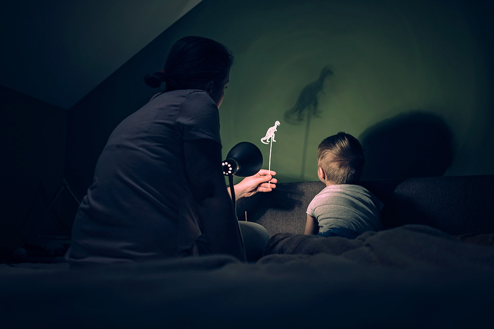 Mother and little boy playing with shadows