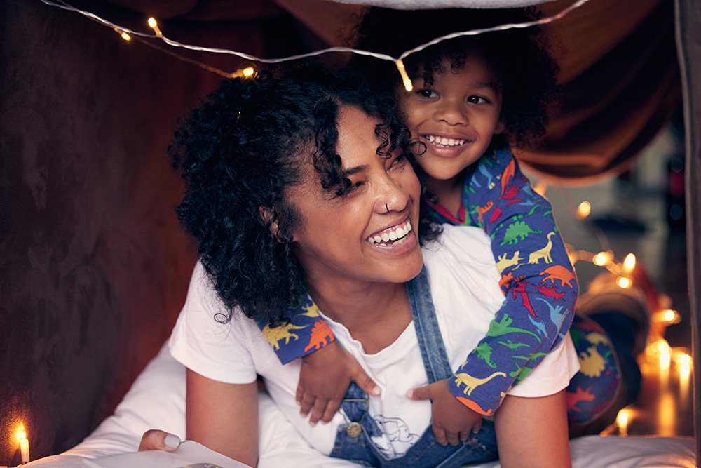 Shot of a woman and her son being playful at home in a pillow fort