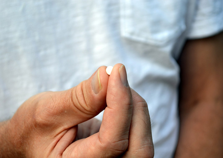 man holding a melatonin pill - can you overdose on melatonin?