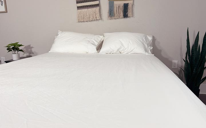 An image of the Quince Sateen sheets dressed on a bed.