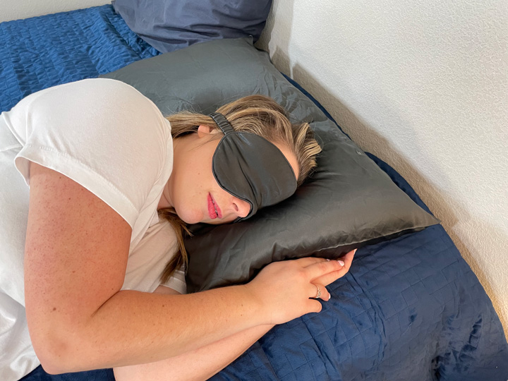 a woman sleeps on a silk pillowcase