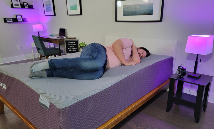 A man sleeps on his side on the Purple RestorePlus mattress