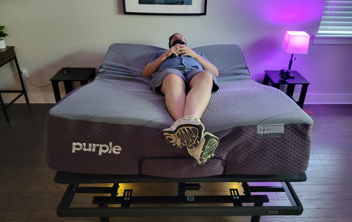 A man uses the Zero Gravity function on the Purple Premium Plus base