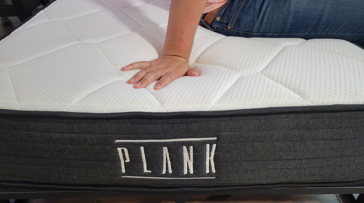A man presses into the Plank mattress