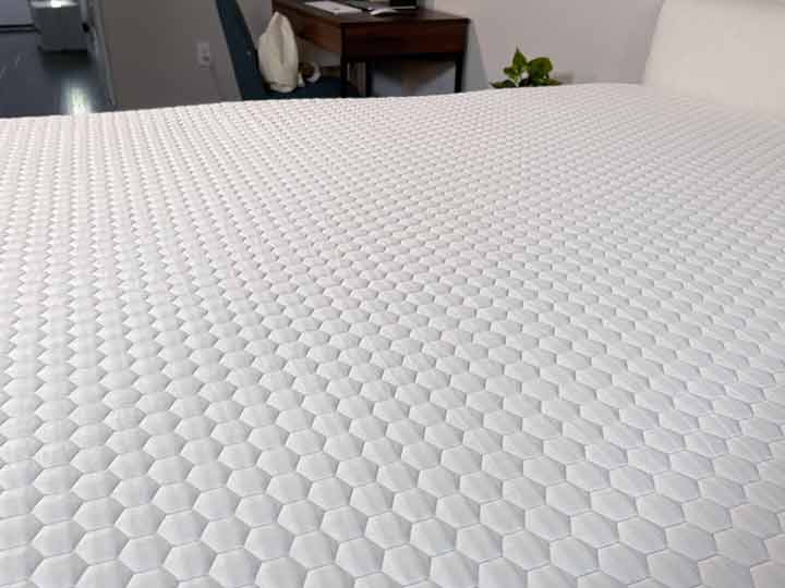 An image of the Bear Pro Mattress Topper's cover. It's made of polyester and has a hexagon pattern.
