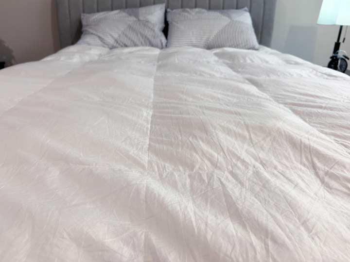 A close up image of the Brooklinen Down Alternative Comforter's cotton shell.