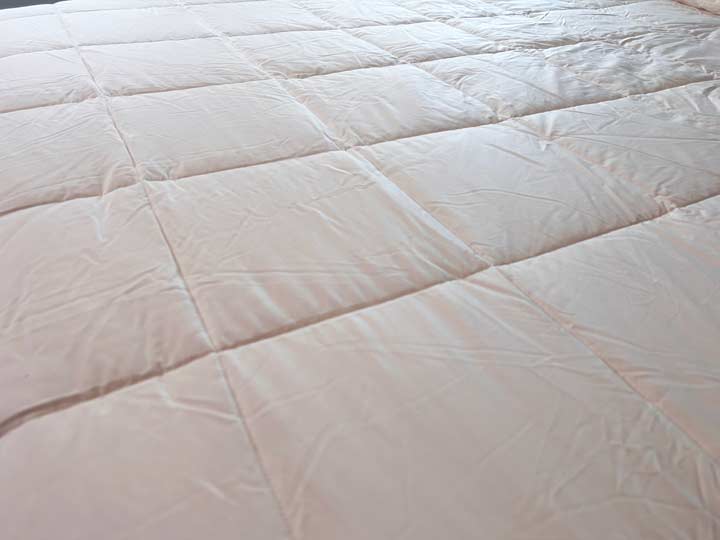 A close up image of the Nest Wool Comforter's cotton cover.
