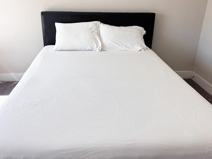 An image of a bed dressed with the Plushbeds Bamboo Sheets.