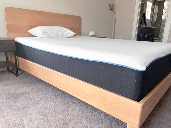 An image of a bed resting on the Avocado City Bed Frame