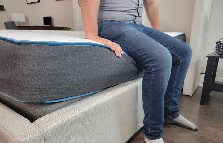 A man sits near the edge of the Bear mattress