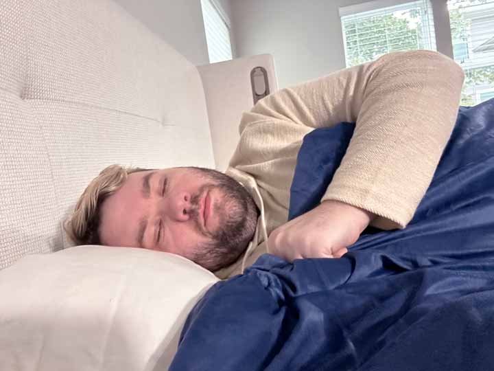 A man sleeps with the Nectar Serenity Weighted blanket.