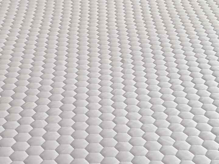 An image showing the GLACIOTEX cover of the Brooklyn Bedding Microcoil Mattress Topper