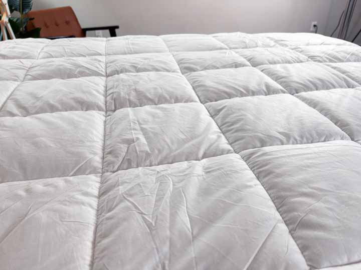 A close up image of the baffle box grid on the Brooklinen Mattress Topper.