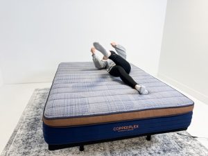 A woman rolling around to test responsiveness on the Brooklyn Bedding CopperFlex mattress