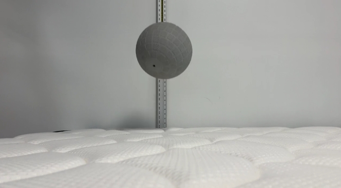 A ball is beng dropped on a DreamCloud Classic Hybrid mattress.