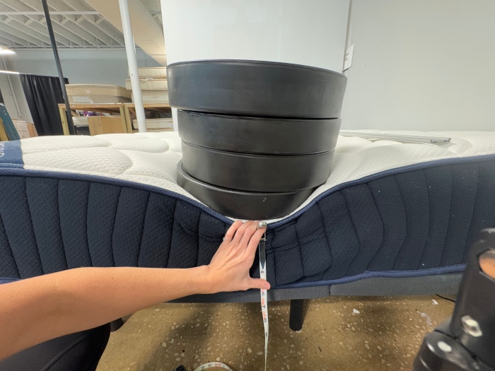 Using weight plates to test edge support on a DreamCloud Classic Hybrid