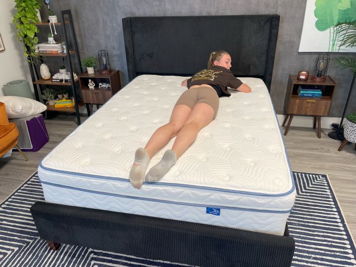 A person laying on their stomach on the DLX Premier Hybrid