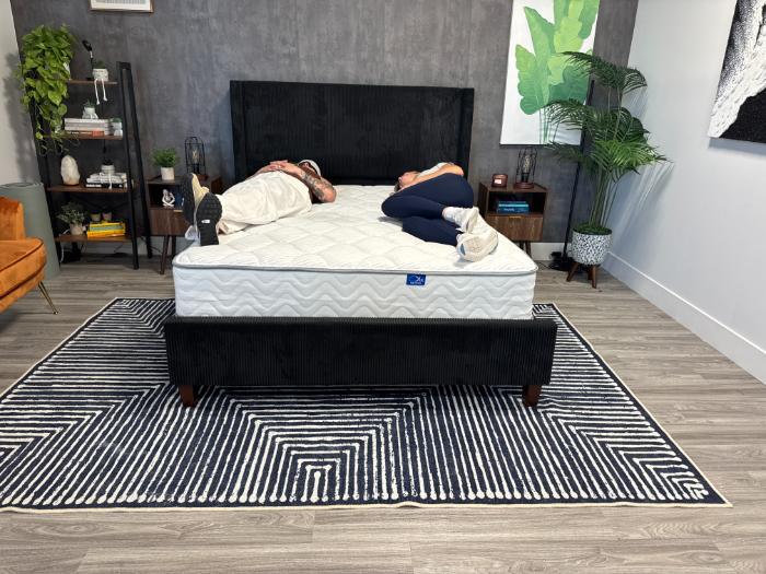 Two women lying on either side of the DLX Classic Two-Sided Mattress