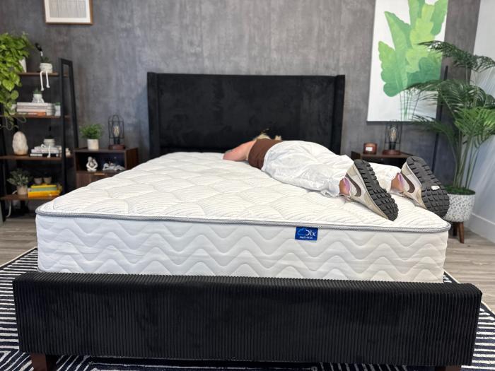 Sosha lying on her stomach on the DLX Classic Two-Sided Mattress