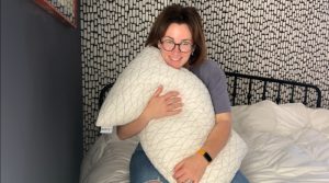 Our tester Nicole Davis hugs a Coop Sleep Goods Original Adjustable Pillow