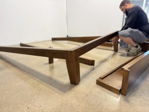 Our tester assembling a Thuma Classic Bed Frame