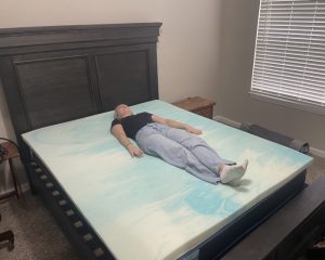 Our tester using a Brooklyn Bedding Gel Swirl Memory Foam Topper