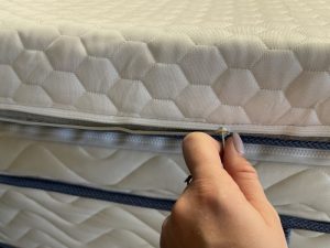 Our tester unzipping the cover on a Bear Pro Topper