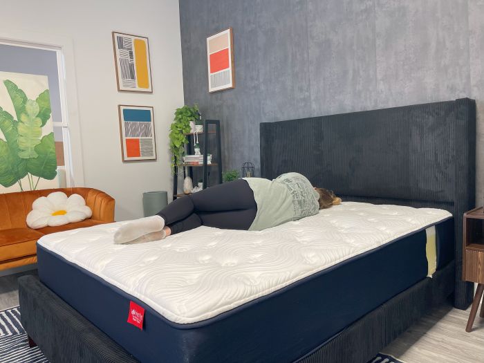 A woman lays on her side on the Big Fig Classic mattress