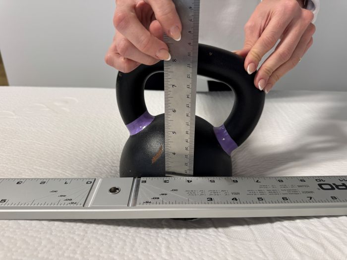 A kettlebell is used to measure sinkage on the Polysleep Luna mattress